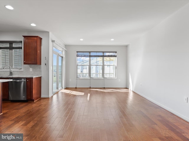 kitchen featuring recessed lighting, dark wood finished floors, dishwasher, and open floor plan