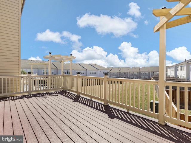 wooden deck with a residential view and a pergola