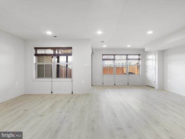 unfurnished room with baseboards, light wood-style flooring, and recessed lighting