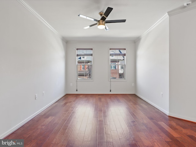 unfurnished room featuring baseboards, wood finished floors, a ceiling fan, and crown molding