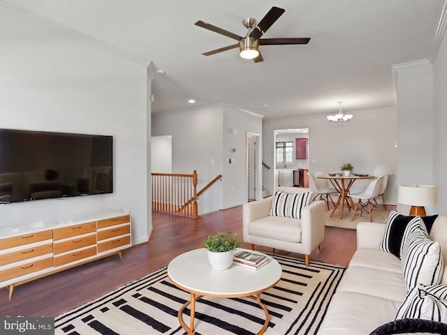 living room featuring ceiling fan with notable chandelier, ornamental molding, wood finished floors, and recessed lighting