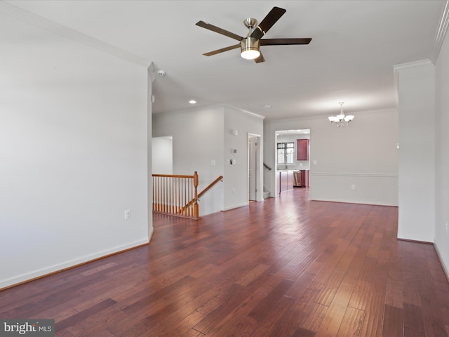 spare room featuring baseboards, dark wood finished floors, crown molding, and ceiling fan with notable chandelier