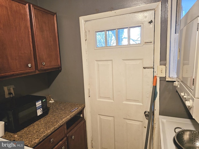 interior space with dark stone countertops and black microwave