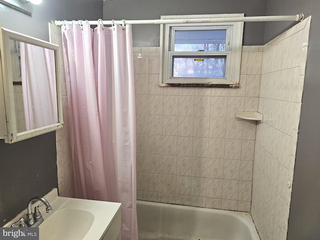 bathroom with shower / bath combo with shower curtain and vanity