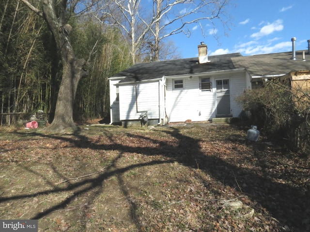 exterior space featuring a chimney and entry steps