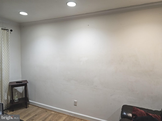 interior space featuring recessed lighting, baseboards, and wood finished floors