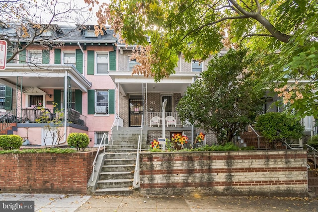 762 Quebec Pl NW, Washington, DC 20010 - townhome / multi-family property with mansard roof, brick siding, a porch, and stairway