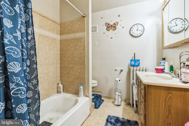 full bath featuring vanity, baseboards, tile patterned flooring, shower / tub combo, and toilet