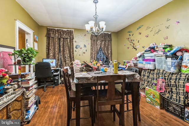 dining room with a notable chandelier and hardwood / wood-style floors