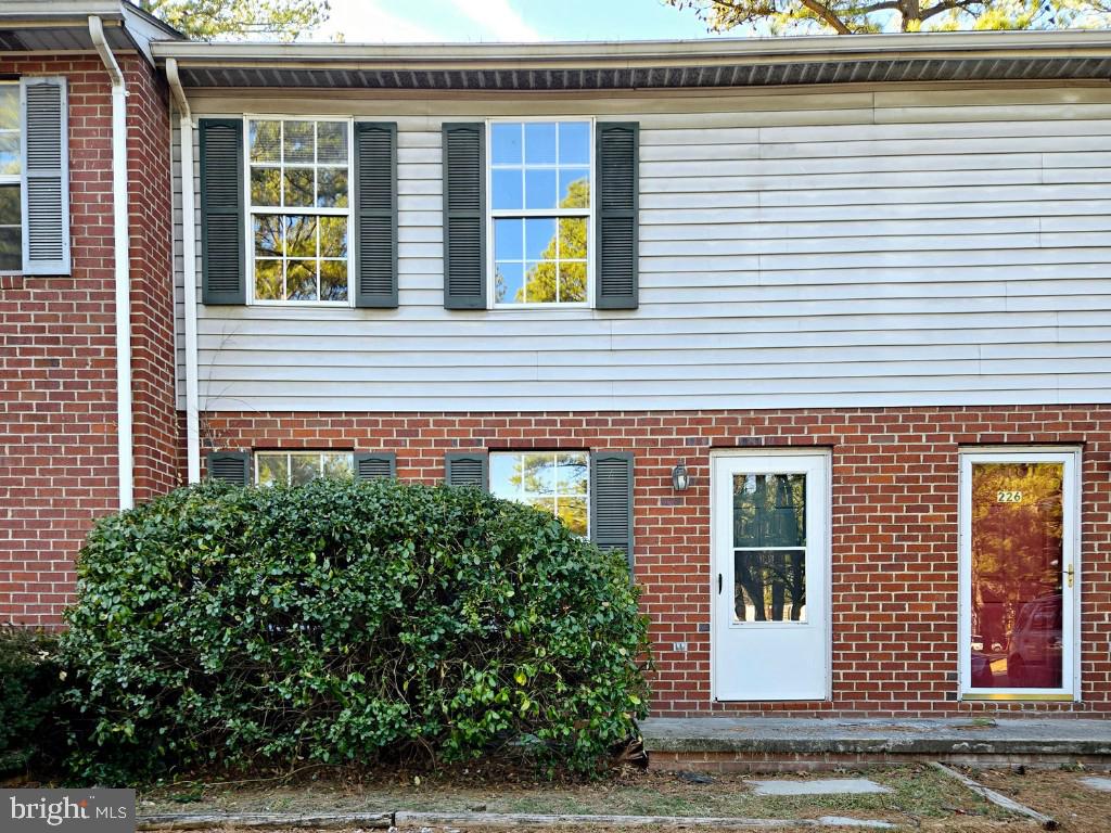 exterior space featuring brick siding