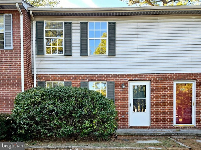 exterior space featuring brick siding