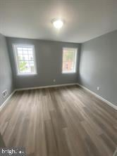 interior space featuring baseboards and wood finished floors