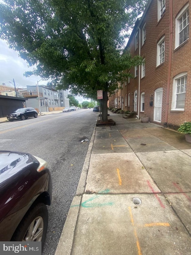 view of road with sidewalks and curbs