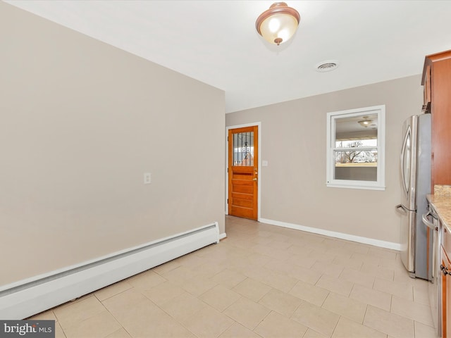 unfurnished room with a baseboard radiator, visible vents, and baseboards