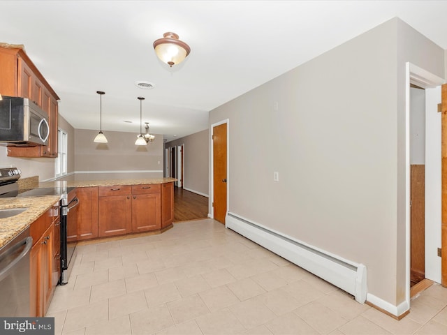 kitchen with brown cabinets, a peninsula, light stone countertops, stainless steel appliances, and a baseboard heating unit