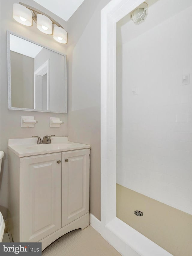 full bathroom with a shower stall, vanity, and toilet