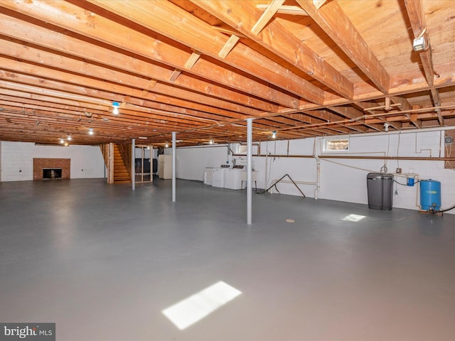 below grade area featuring washing machine and dryer and a fireplace