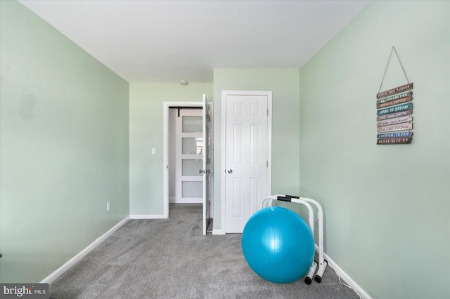 exercise area with carpet and baseboards