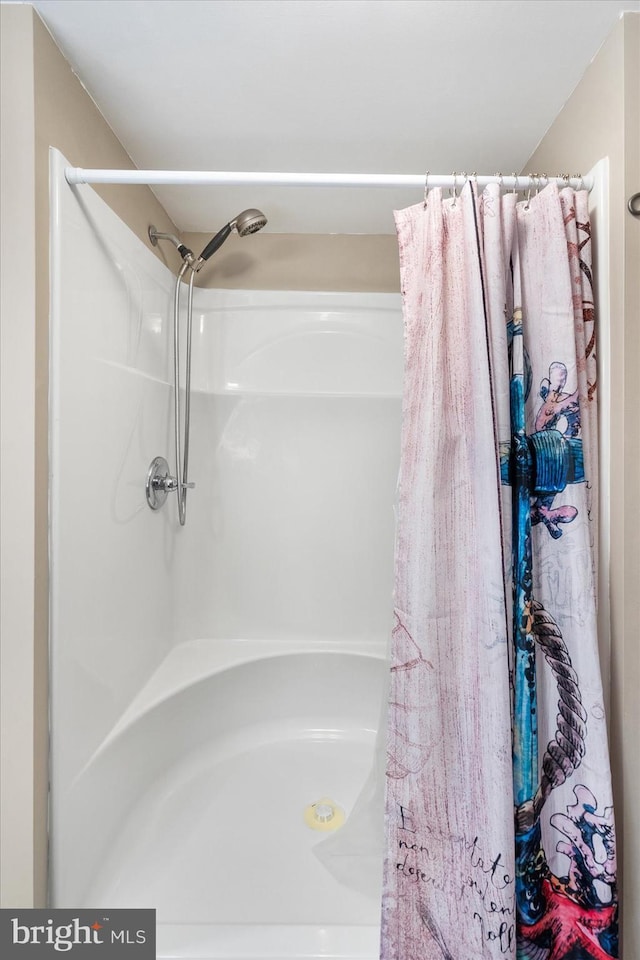 bathroom with a shower with shower curtain