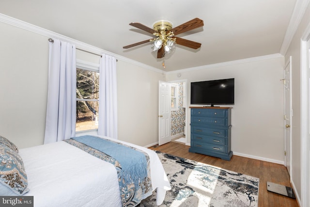 bedroom with baseboards, ornamental molding, ceiling fan, and wood finished floors