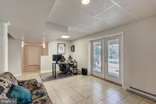 office area with french doors, light tile patterned floors, a paneled ceiling, baseboard heating, and baseboards