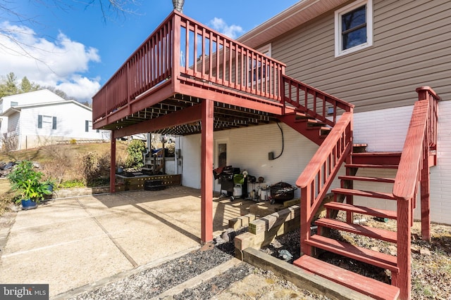 view of patio / terrace with stairs, grilling area, and a wooden deck