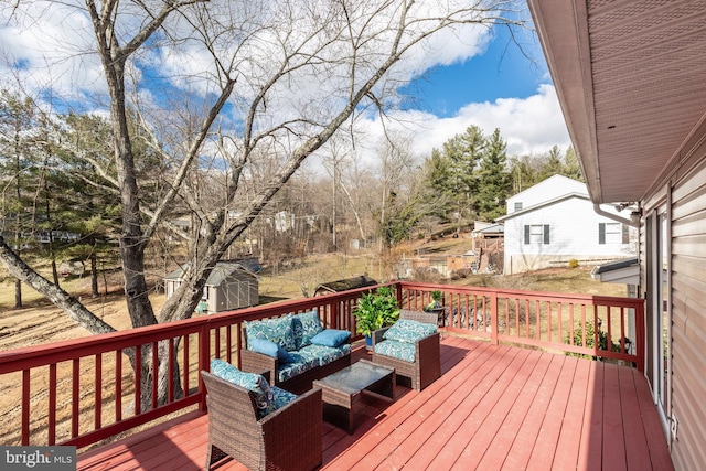 deck with a shed, an outdoor living space, and an outdoor structure