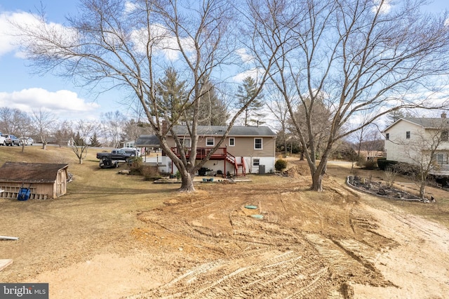 view of front of house with an outdoor structure and a shed