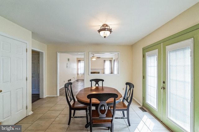 dining room with light tile patterned flooring, visible vents, plenty of natural light, and french doors