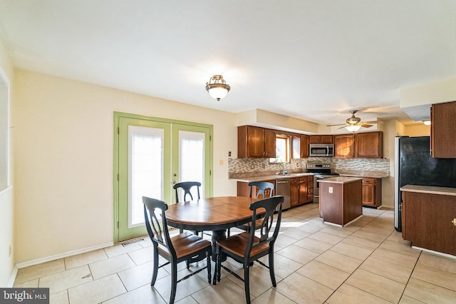 dining room featuring light tile patterned floors, french doors, baseboards, and a ceiling fan