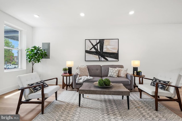 living area with light wood finished floors, baseboards, and recessed lighting