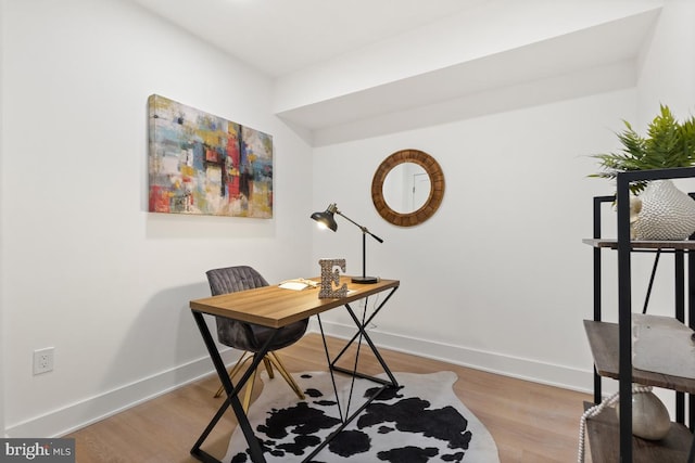 office area with baseboards and wood finished floors