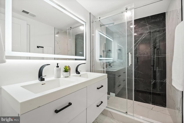 bathroom featuring marble finish floor, a sink, a marble finish shower, and double vanity