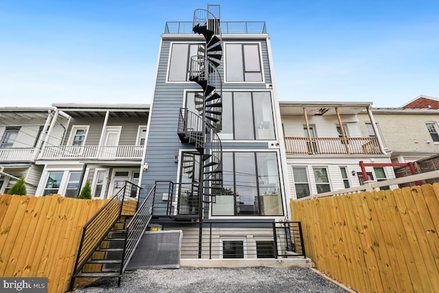 view of front of house featuring fence and stairs