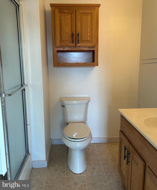 full bath with baseboards, toilet, a shower with door, tile patterned floors, and vanity