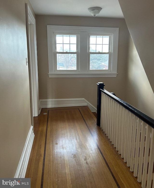 interior space with baseboards, a healthy amount of sunlight, and light wood finished floors