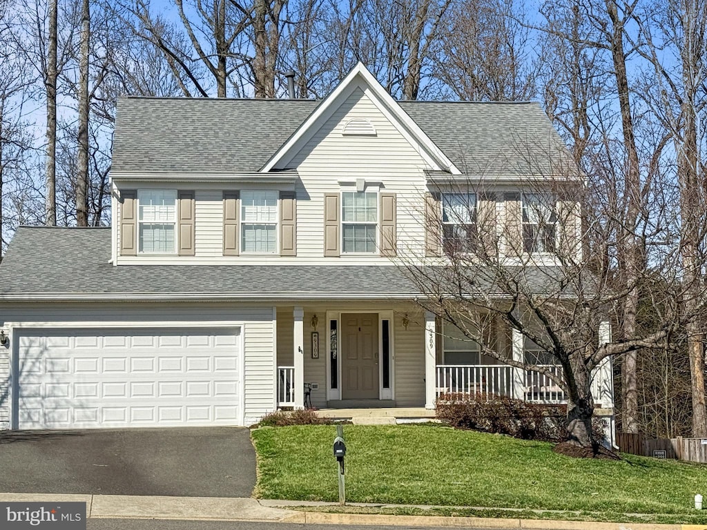 view of front of property with a shingled roof, a front lawn, aphalt driveway, covered porch, and a garage