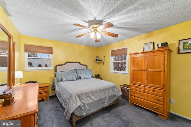 carpeted bedroom featuring a textured ceiling, a ceiling fan, and baseboards