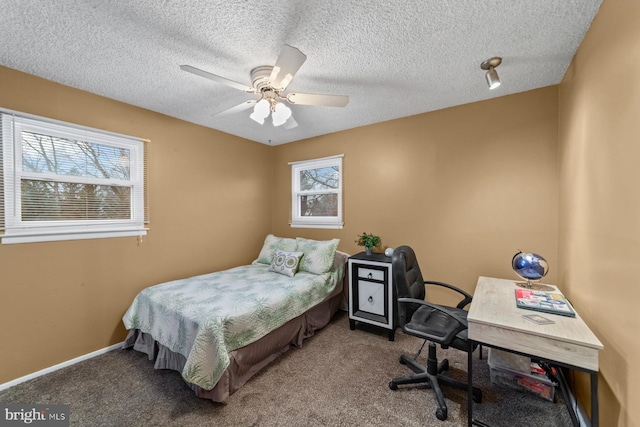 carpeted bedroom with a textured ceiling, ceiling fan, and baseboards