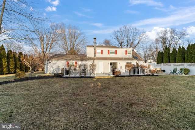 back of property with a patio area, fence, and a yard