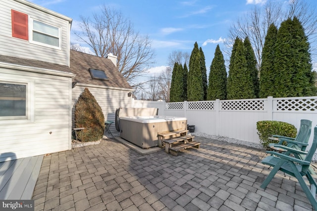 view of patio / terrace featuring a fenced backyard and a hot tub