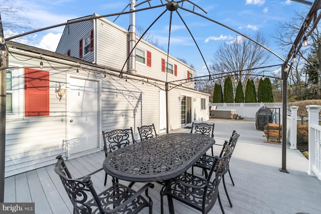 wooden terrace featuring outdoor dining space and fence