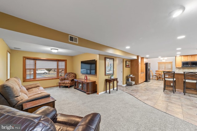 living area featuring light tile patterned flooring, recessed lighting, light carpet, visible vents, and baseboards