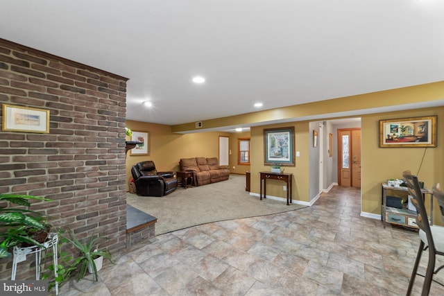 living room with brick wall, recessed lighting, stone finish flooring, and baseboards