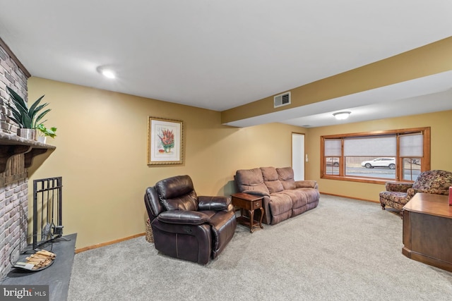 living area featuring a brick fireplace, carpet, visible vents, and baseboards