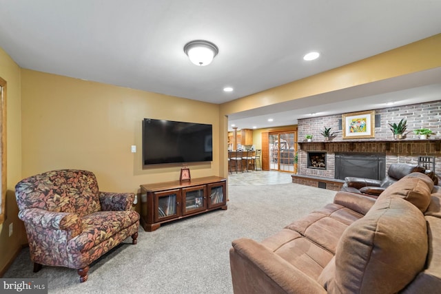 living area featuring a brick fireplace, carpet flooring, and recessed lighting