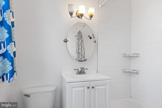 bathroom featuring shower / tub combo, vanity, and toilet