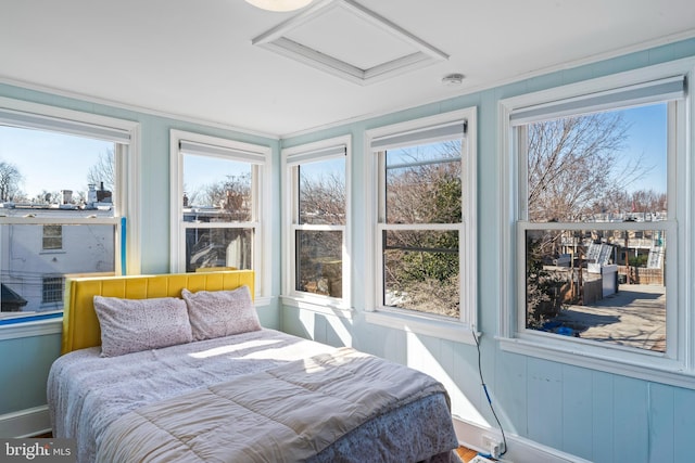 bedroom featuring multiple windows and attic access