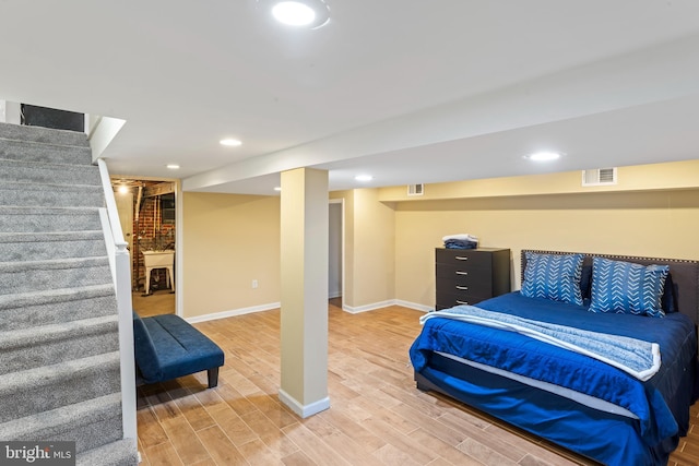 bedroom with light wood-type flooring, visible vents, baseboards, and recessed lighting