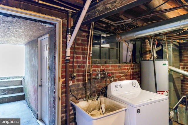 laundry area featuring laundry area, washer / clothes dryer, gas water heater, and a sink